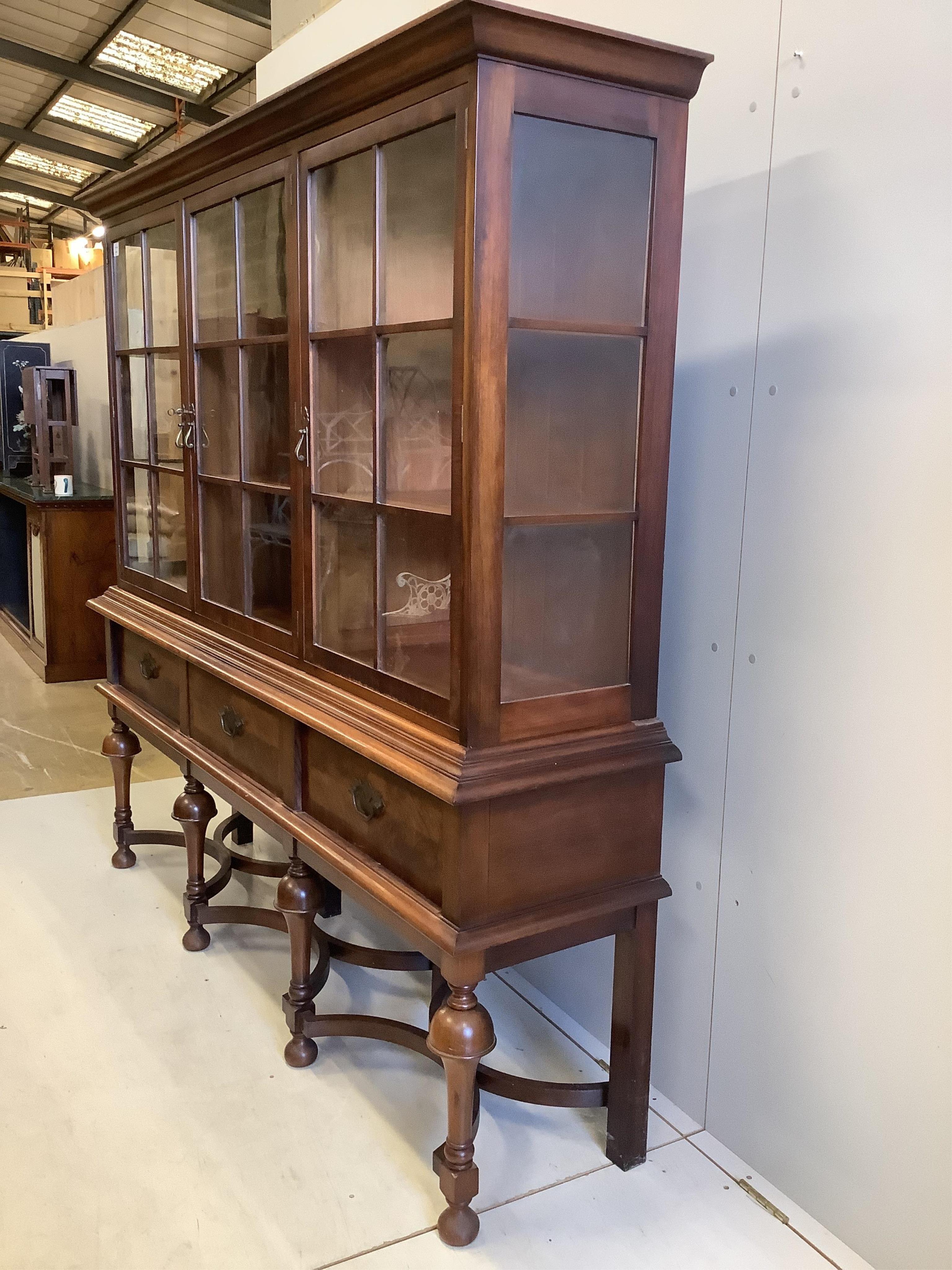 An early 20th century Dutch style walnut display cabinet, width 188cm, depth 44cm, height 180cm. Condition - fair to good